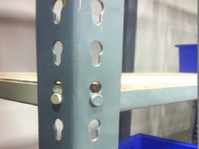 A single rivet example: Notice it appears similar to a double rivet racking system, however with only one
	rivet holding the weight which offers a lower shelf profile.